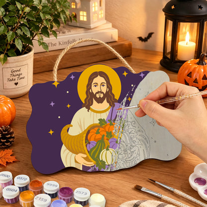 Pancarte Christ et Corne d'Abondance en cours de peinture, pinceau à la main — Maison Artsen