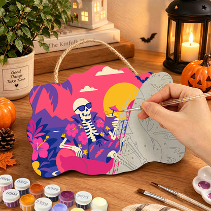 Pancarte Squelette au Soleil en cours de peinture, pinceau à la main — Maison Artsen